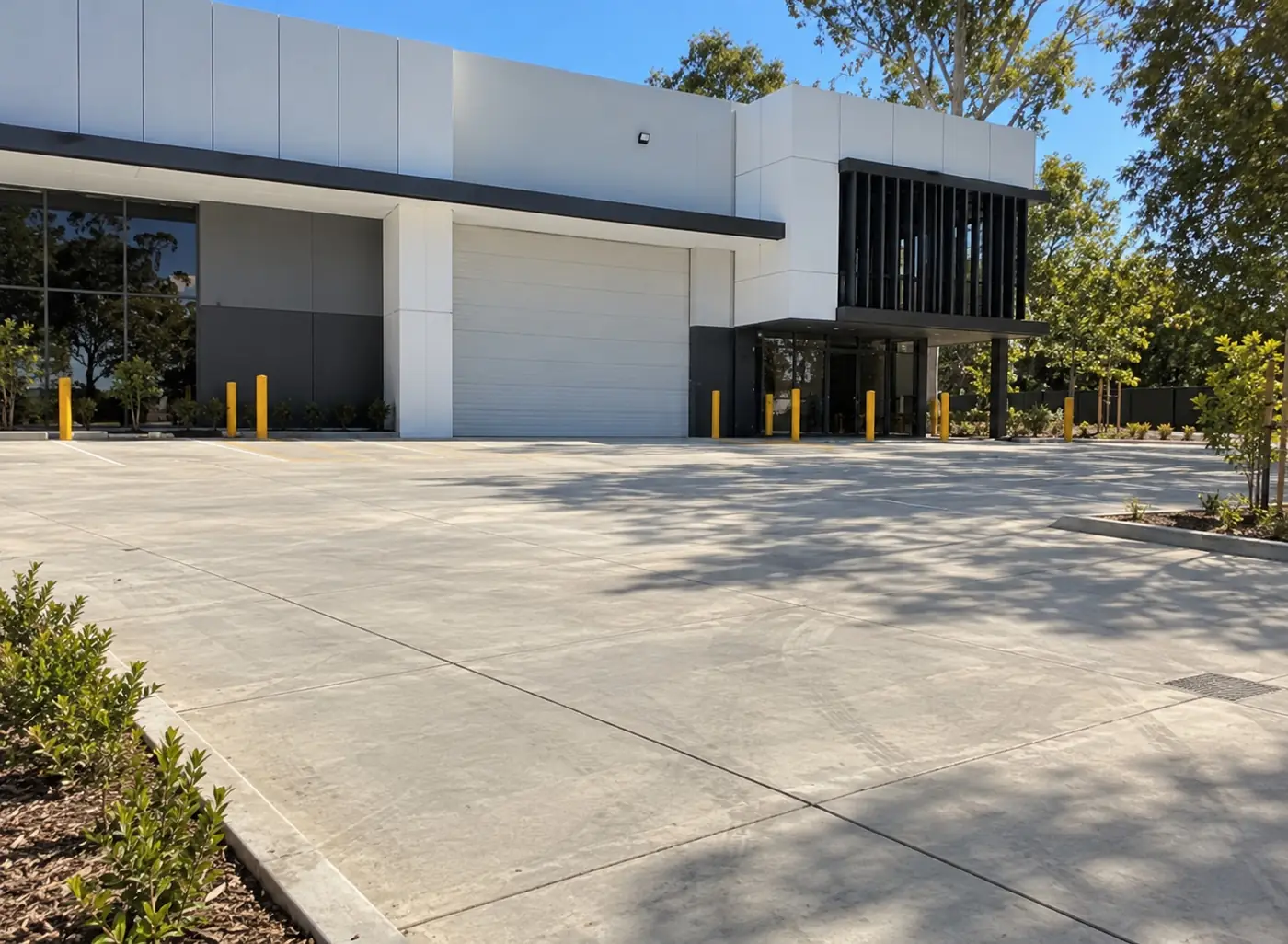 Broad concrete forecourt in front of a modern industrial building