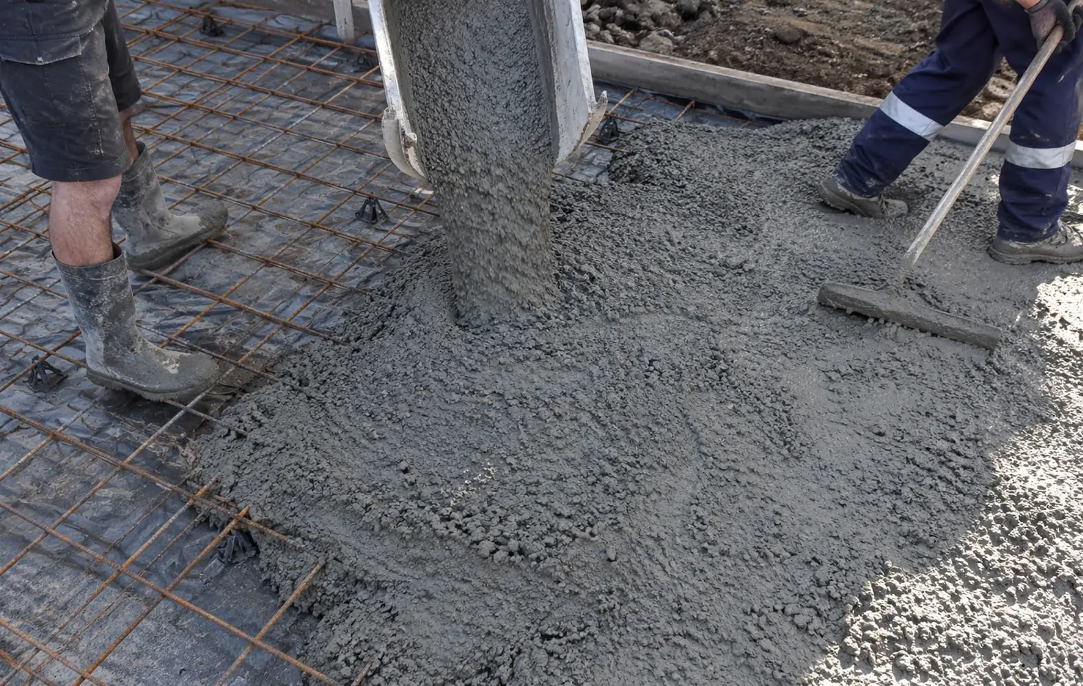 Concrete being pumped over steel reinforcement on a Wollongong slab