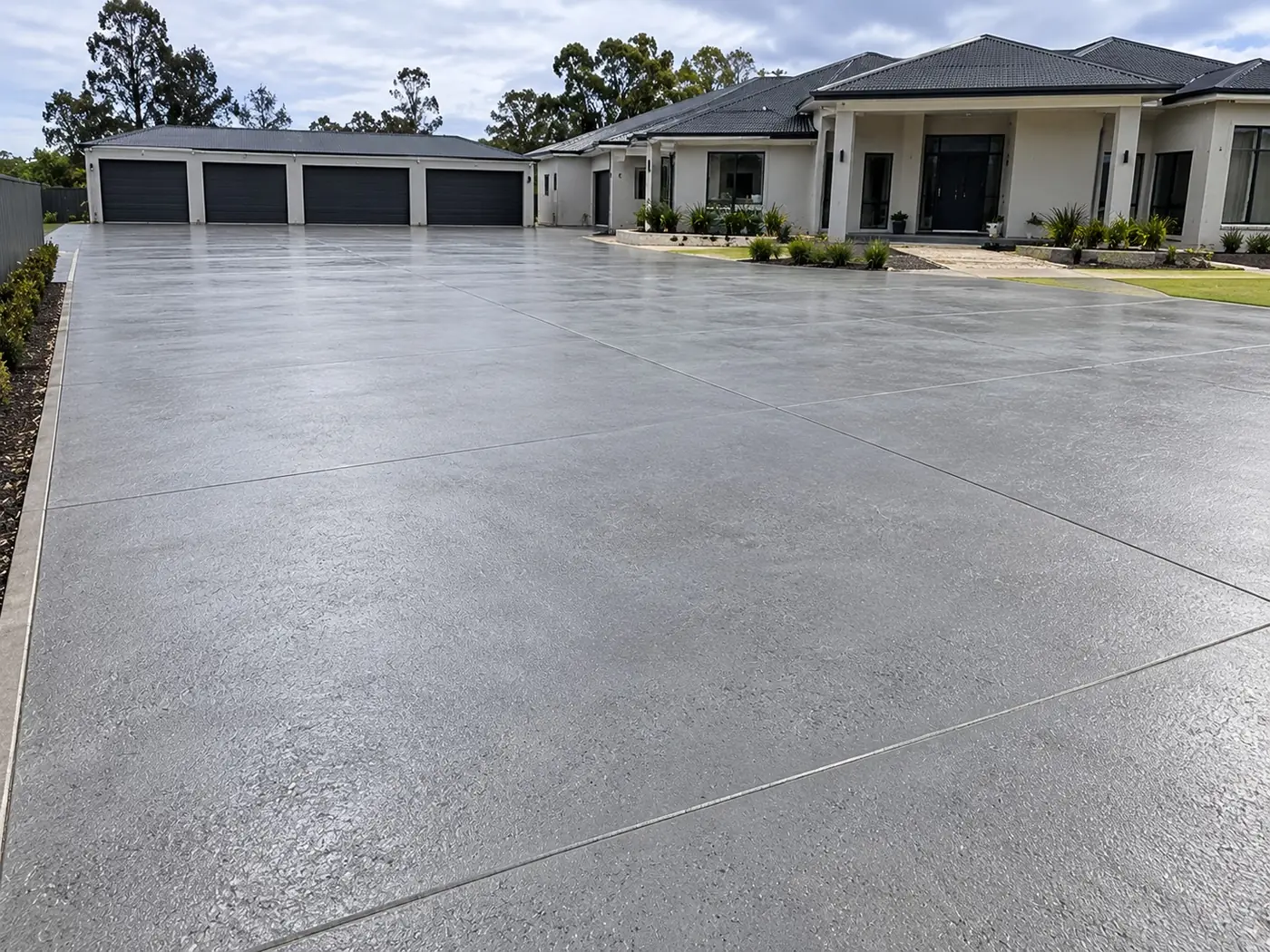 Large resurfaced concrete driveway and turning area at a new home